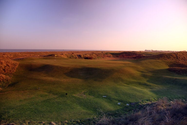 Early morning image of a green on the golf course at Royal Cinque Ports Golf Club, Kent, England