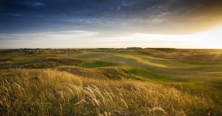 Landscape image of the sunset over the 17th hole at Royal Cinque Ports Golf Club, Kent, England