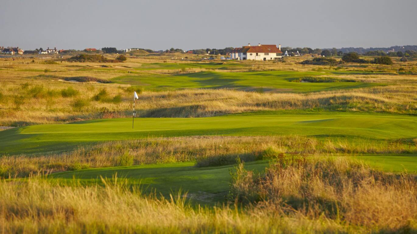 Landscape image over the golf course with the main resort buildings in the background at Prince's in Sandwich, Kent, England, United Kingdom