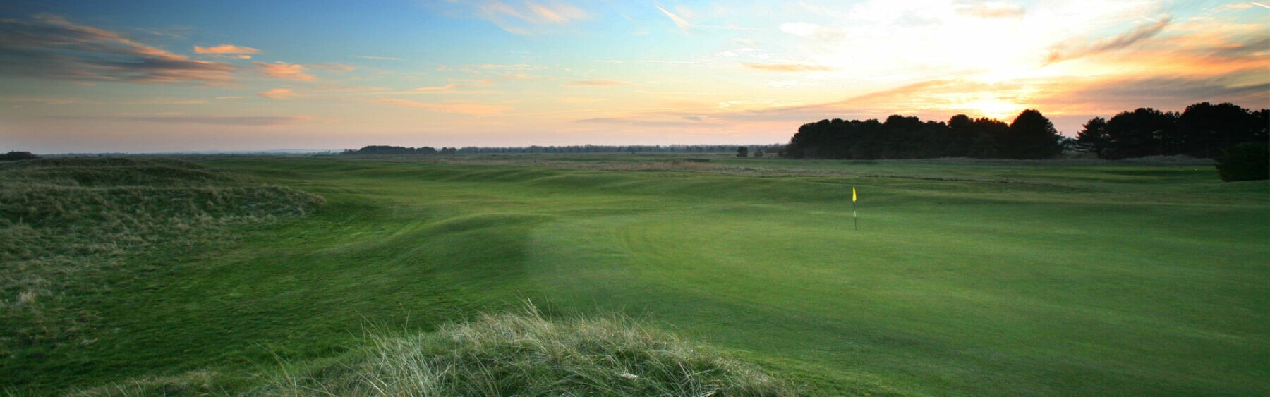 Wide panoramic view of a green at dawn at Prince's in Sandwich, Kent, England, United Kingdom