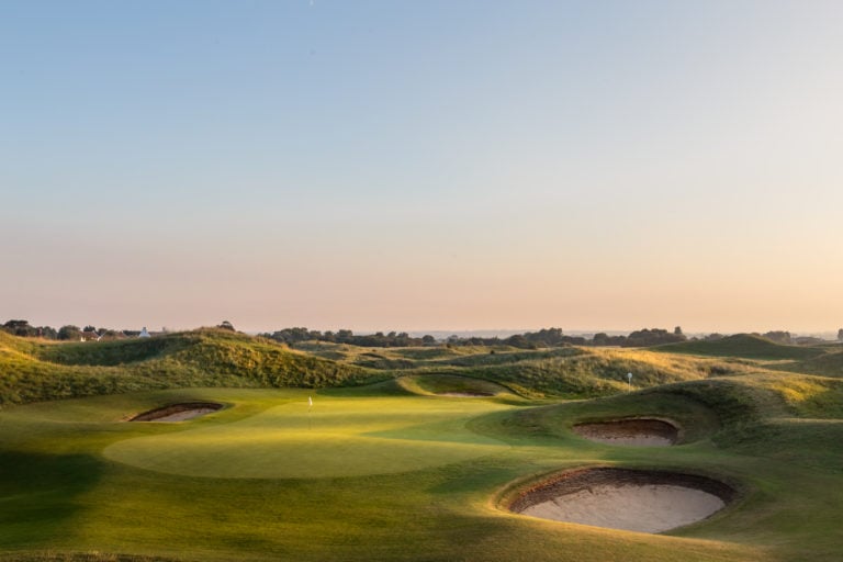 Image of the 6th green surrounded by pot bunkers and undulating hills at Royal St. George's Golf Club, Kent, England