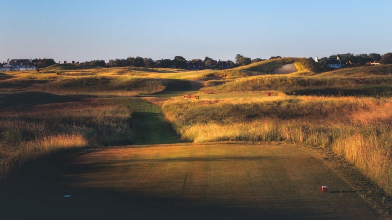 Mage looking down the fourth fairway from the tee with golden sunlight touching the terrain, Royal St. George's Golf Course, Kent, England