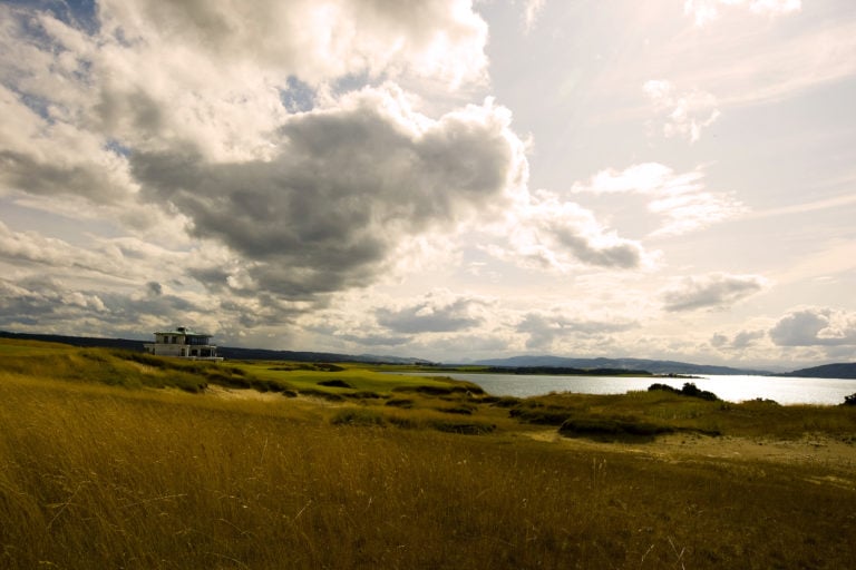 Image overlooking the 18th hole and clubhouse with long reeds at Castle Stuart Golf Links, Inverness, Scotland