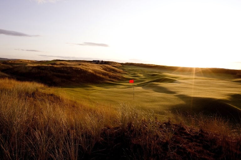 Image overlooking the 14th hole at dusk on the Castle Stuart Golf Links, Inverness, Scotland
