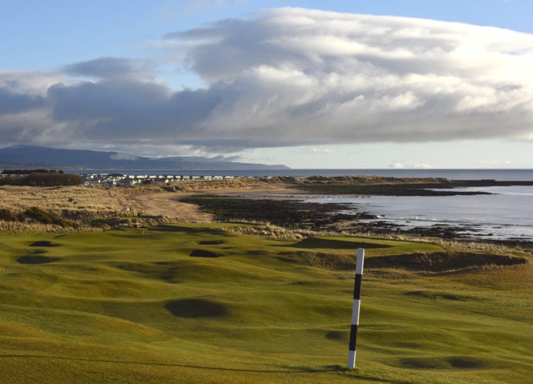 Image depicting the par-4 8th hole looking to the town of Dornoch and the sea at Royal Dornoch Golf Club, Scotland