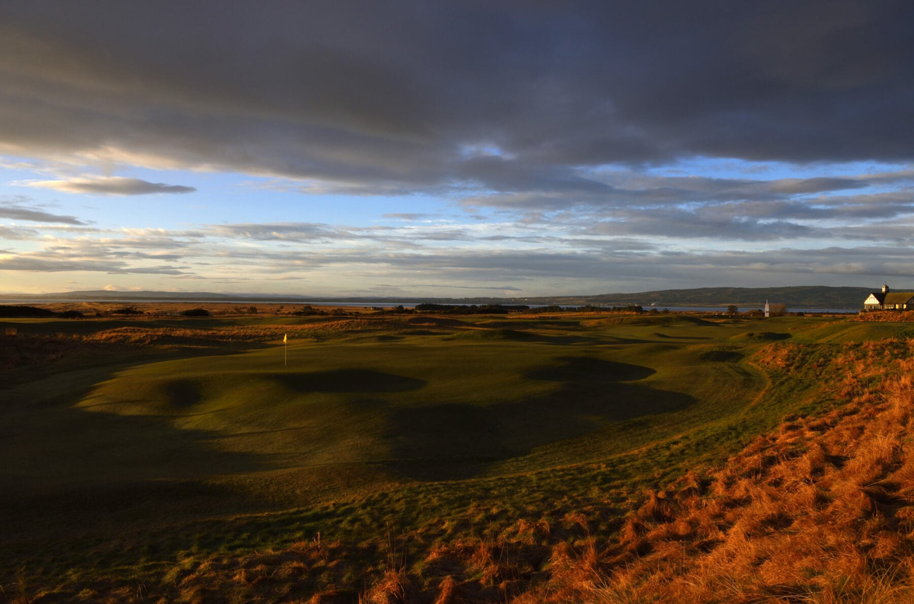 Image of a wintery sunrise over the par-4 1st hole at Royal Dornoch Golf Club, Scotland