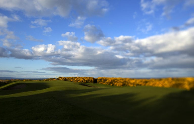 Image overlooking fairway gorse and the sky over the par-3 2nd hole at Royal Dornoch Golf Club, Scotland