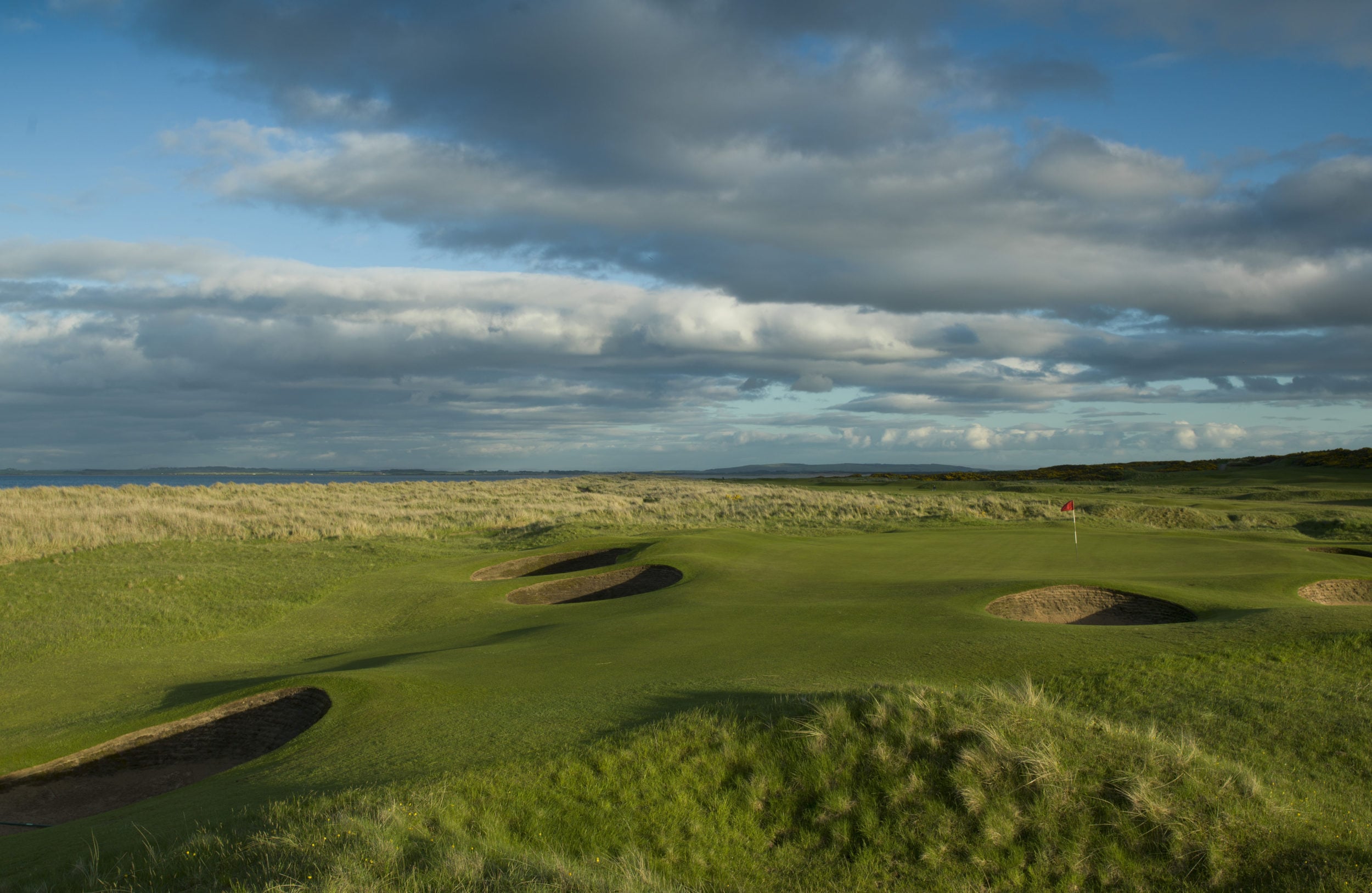 Image depicting the par-3 13th hole with many pot bunkers at Royal Dornoch Golf Club, Scotland