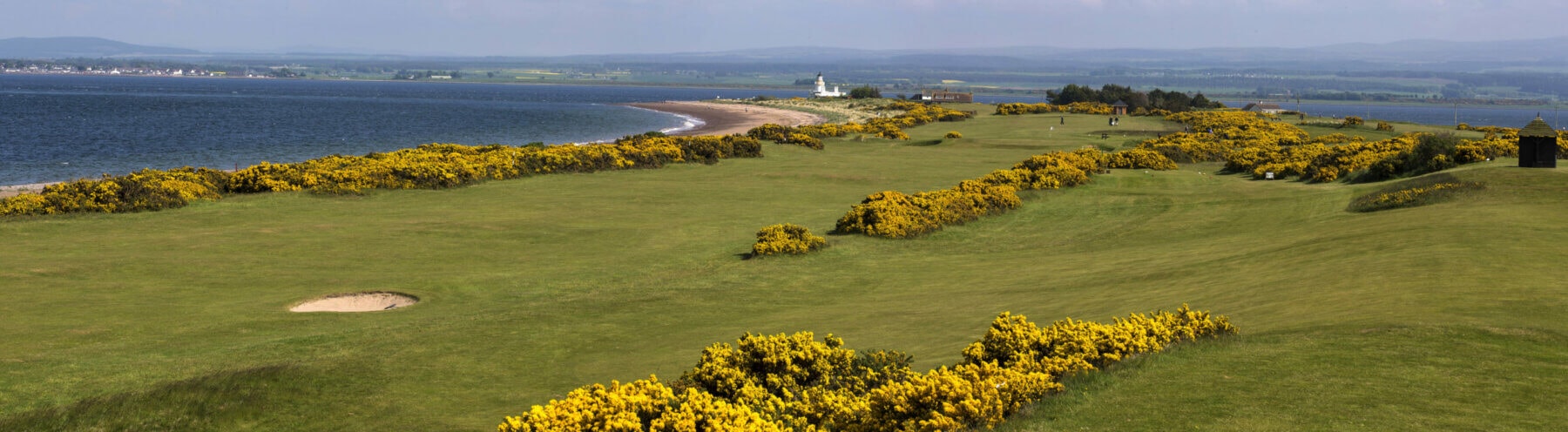 Image of the beach in the background and golf course in the foreground at Fortrose and Rosemarkie golf Links, Inverness, Scotland