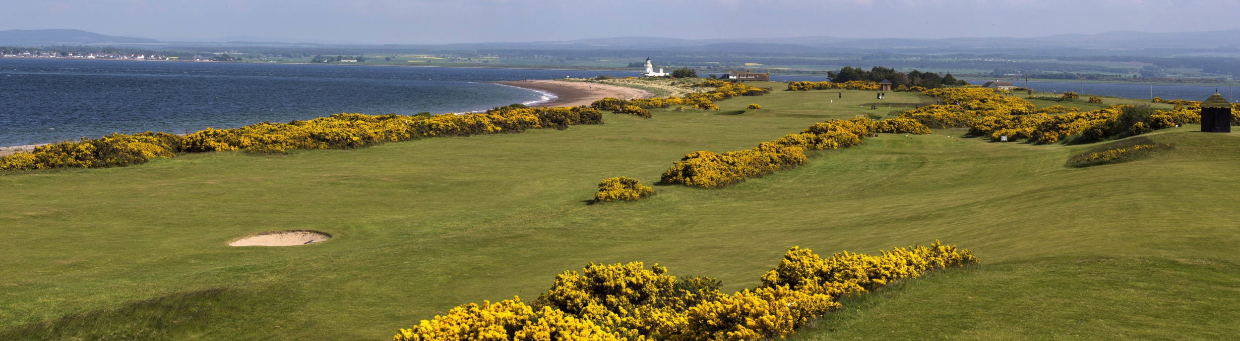 Image of the beach in the background and golf course in the foreground at Fortrose and Rosemarkie golf Links, Inverness, Scotland