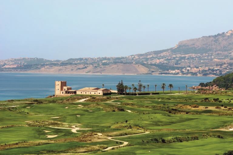 Image of the golf course, Sicilian buildings and Mediterranean Sea at Verdura Resort, Sicily, Italy