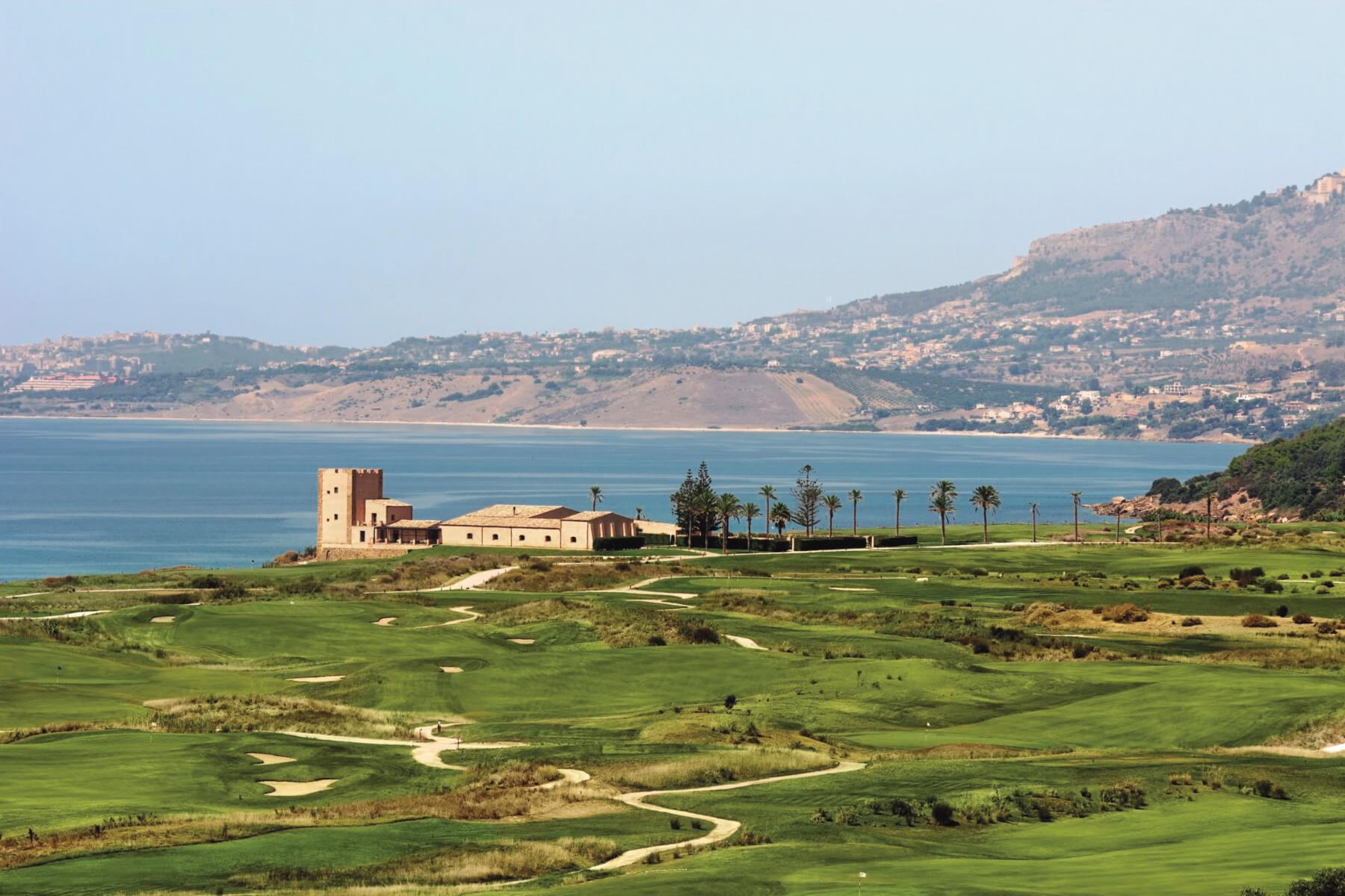 Image of the golf course, Sicilian buildings and Mediterranean Sea at Verdura Resort, Sicily, Italy
