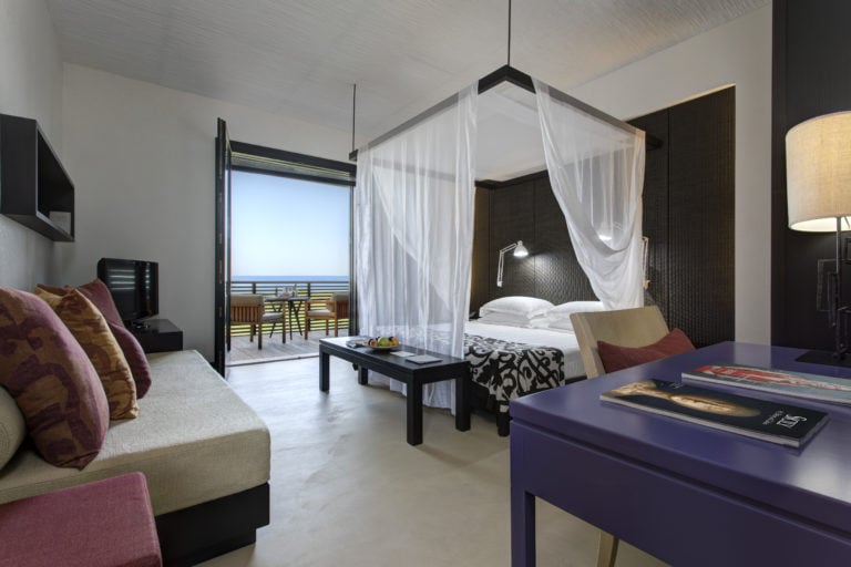 Image displaying a deluxe room four-poster bed at Verdura Resort, Sicily, Italy