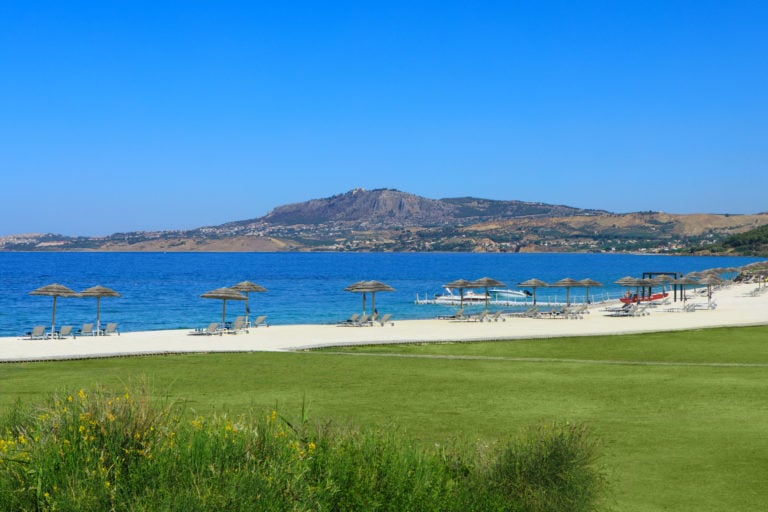 Image depicting the beach and distant hill at Verdura Resort, Sicily, Italy