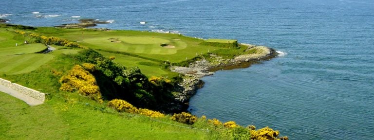 Image looking down at the 13th green on a sunny day at Ardglass Golf Club, Northern Ireland