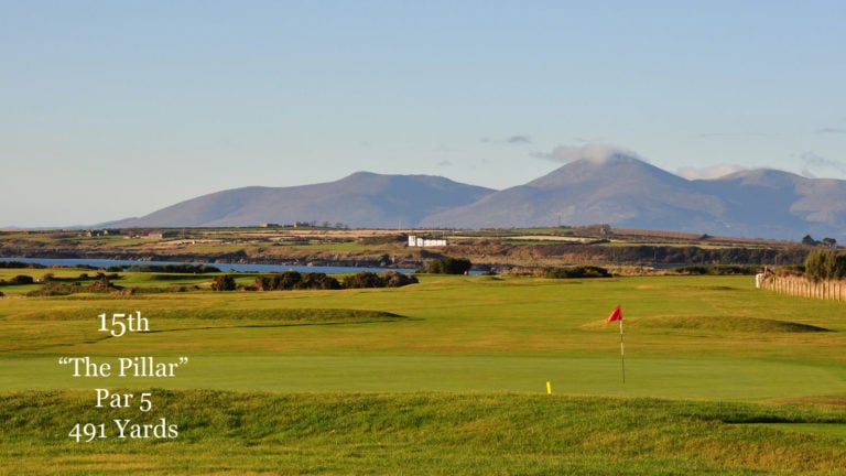 Image of the 15th green with large mountains in the background