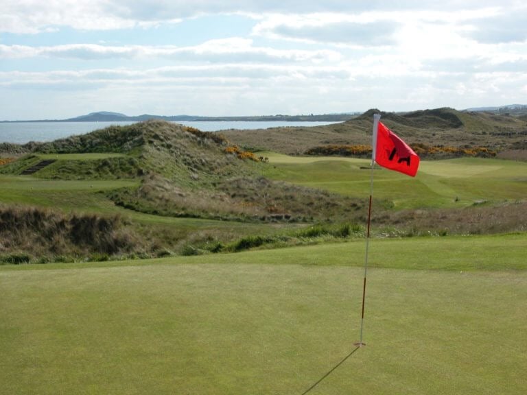 Image depicting a red flag on a par-3 green at The European Golf Club, Ireland