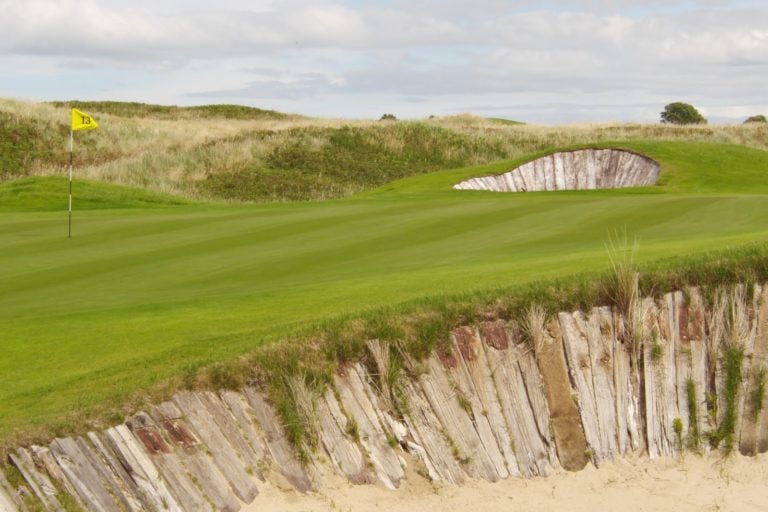 Image depicting the 13th green with the classic Railway Sleeper Bunkers at The European Golf Club, Ireland