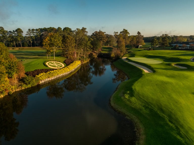 Image depicting the 18th green opposite the Resort logo and the River James at Kingsmill Resort, Williamsburg Virginia, USA