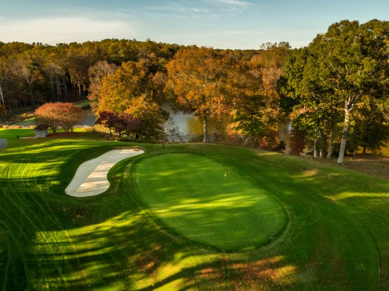 Aerial image of the 12th green in autumn on the River Golf Course at Kingsmill Resort, Williamsburg Virginia, USA