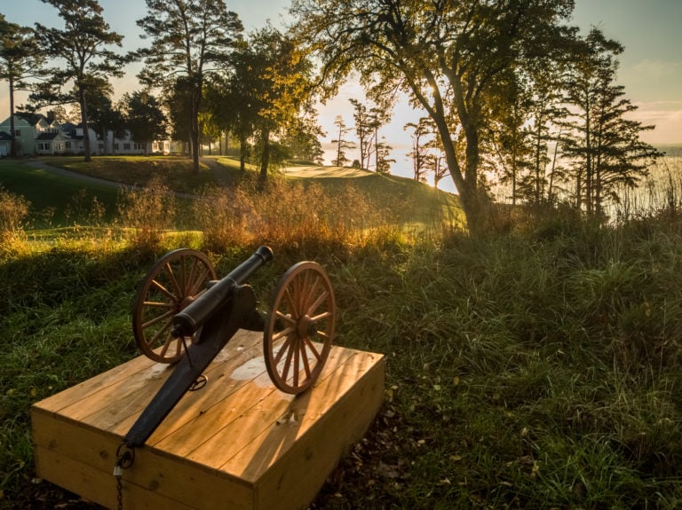 Image of an old cannon at sunrise on the River Golf Course at Kingsmill Resort, Williamsburg Virginia, USA