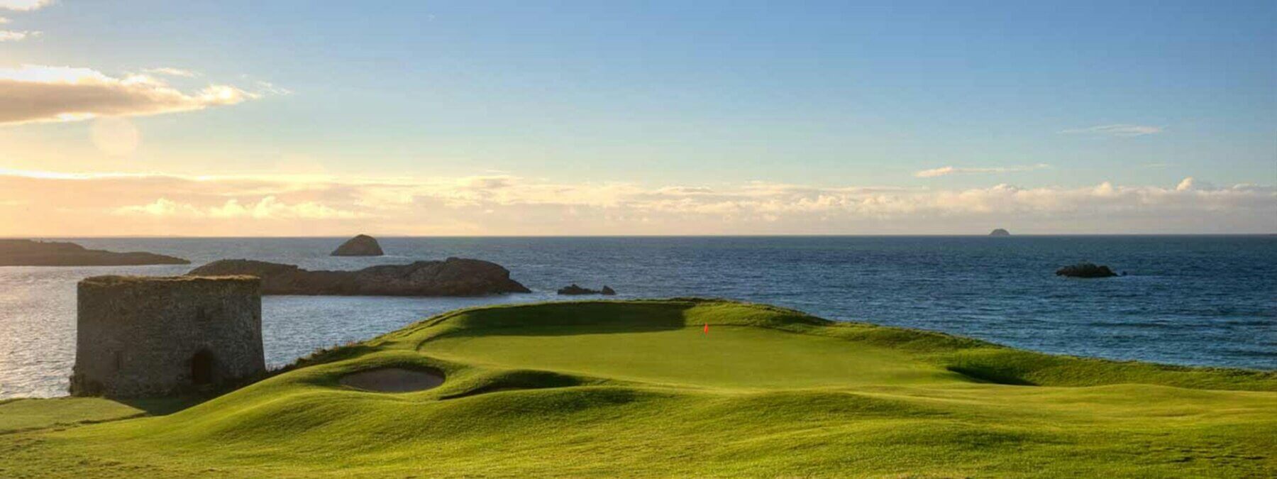 Landscape image of the signature 3rd hole par 3 with the ruins of a castle adjacent, Tralee Golf Club, County Kerry, Ireland