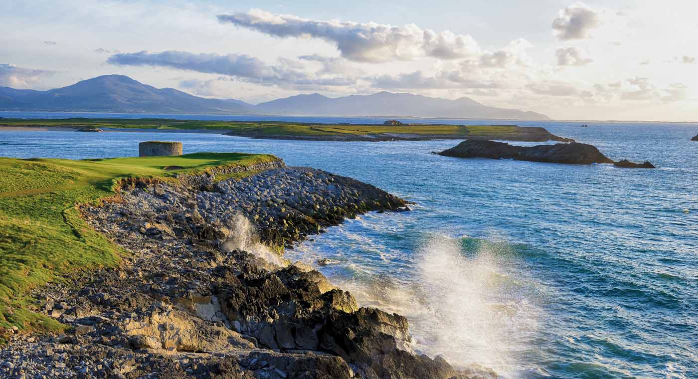 Image of an outcrop and sea spraying over the rocks at Tralee Golf Club, County Kerry, Ireland