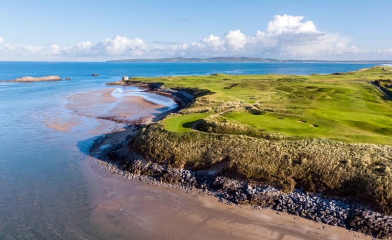 Aerial image of the golf course contrasting with white sandy beaches and blue waters at Tralee Golf Club, County Kerry, Ireland