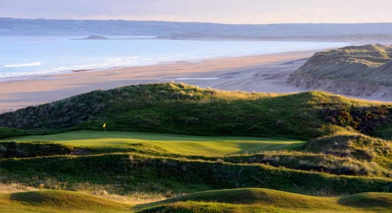 Image depicting a green and sandy beach in the background at Tralee Golf Club, County Kerry, Ireland