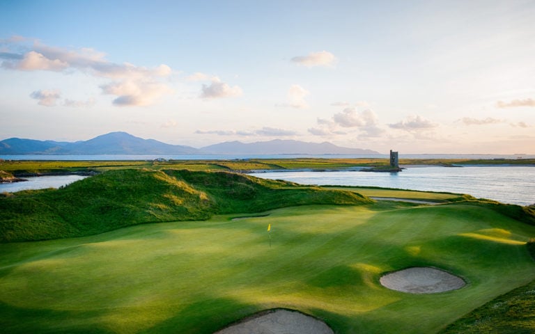 Aerial view of a green and distant castle, Tralee Golf Club, County Kerry, Ireland