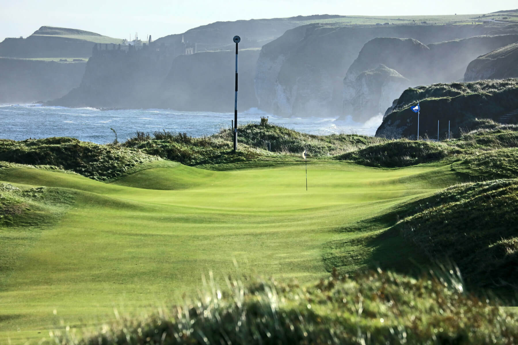 Image of a narrow fairway leading to Dunluce Castle, Royal Portrush Dunluce Golf Course, Portrush, County Antrim, Northern Ireland