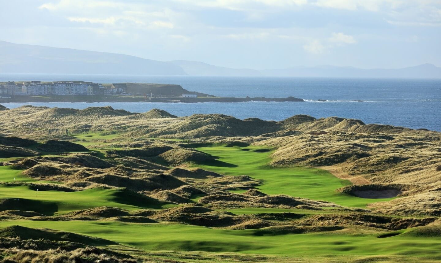 Image depicting the 7th hole and distant township of Portrush at Royal Portrush Dunluce Golf Course, Portrush, County Antrim, Northern Ireland