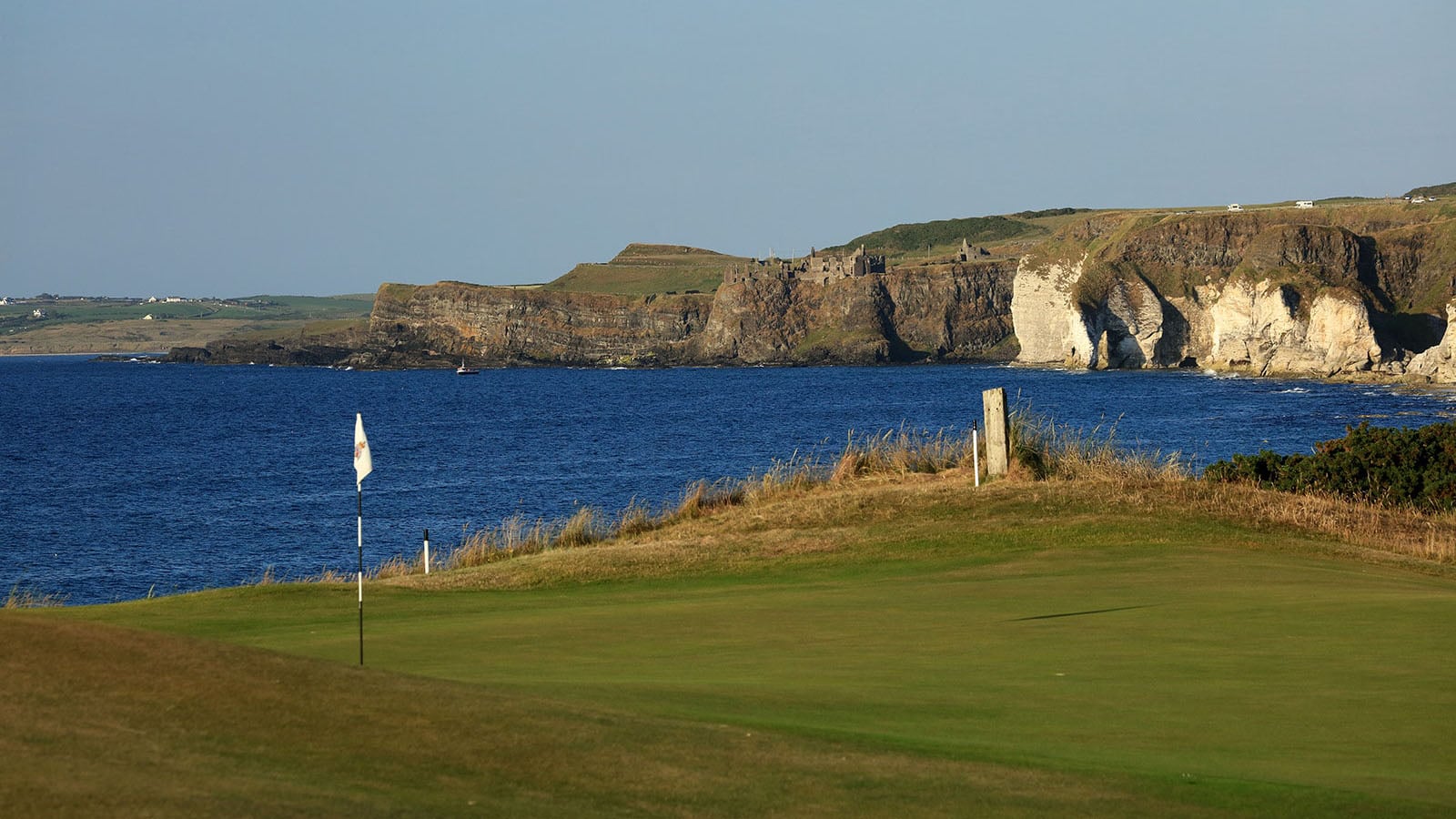 Image of the 6th green and distant Dunluce Castle ruins at Royal Portrush Dunluce Golf Course, Portrush, County Antrim, Northern Ireland
