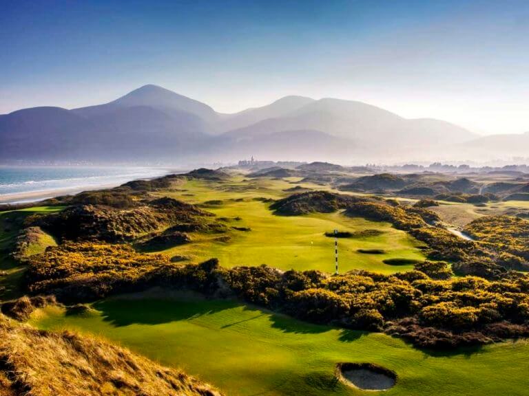 Image overlooking the 2nd hole in the morning mist at Royal County Down Golf Club, Northern Ireland