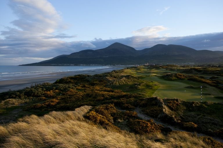 Image depicting the beach and mountains surrounding the Royal County Down Golf Club, Northern Ireland