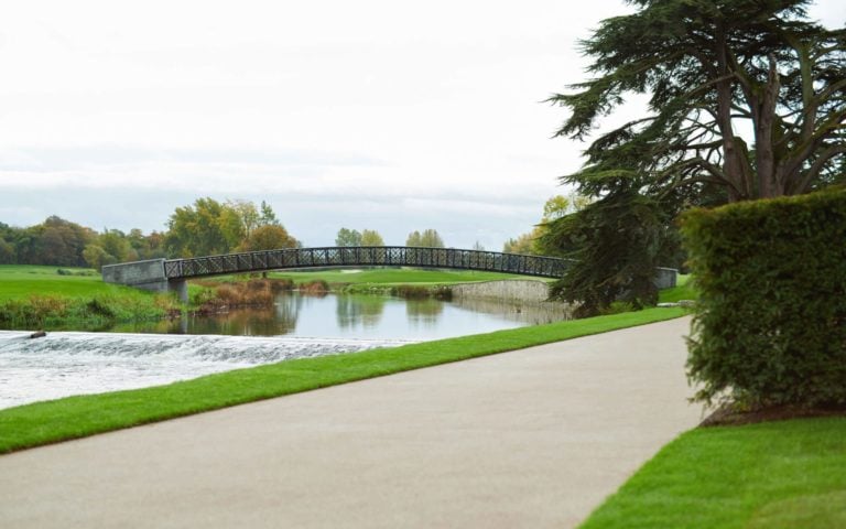 Image depicting a wide bridge over the river along viewed from a pathway at Adare Manor, County Limerick, Ireland, Europe