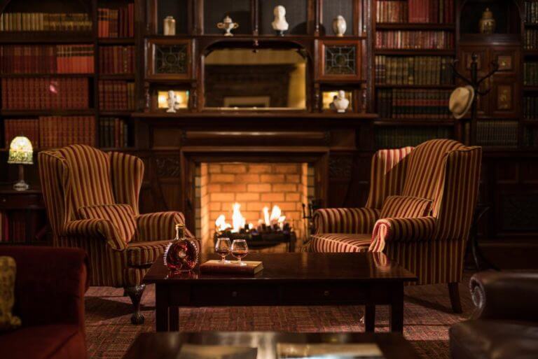 Image of the inside of the Blaney Bar with alcohol and a log fire, Lough Erne Resort, Fermanagh Count,Northern Ireland, United Kingdom