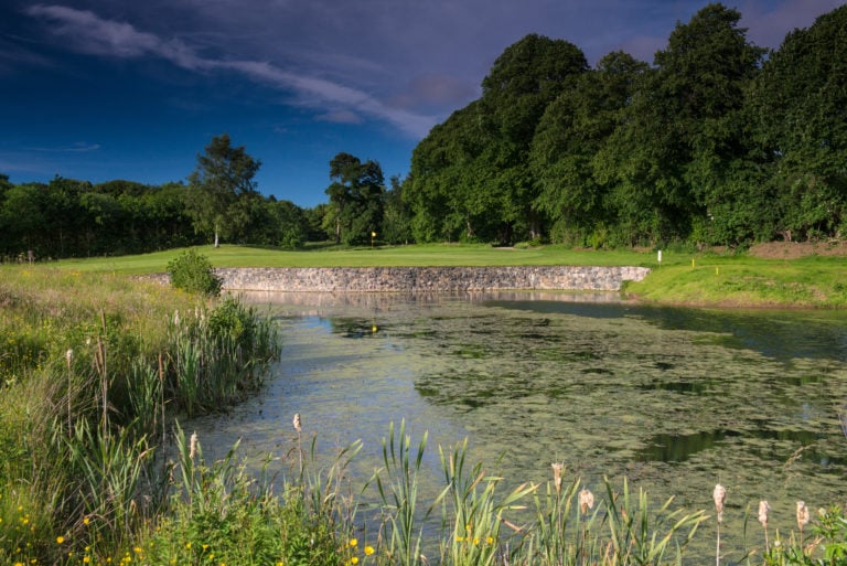Image of the par-3 7th green over a lake at Galgorm Resort, County Antrim, Northern Ireland