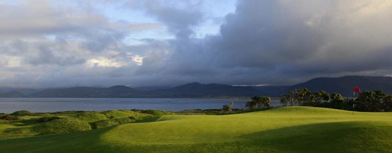 Image of a green in the foreground and sea in the background, Dooks Golf Club, County Kerry, Ireland
