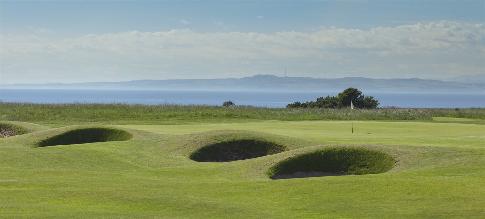 Image displaying pot bunkers, green and the sea at Gullane No.2 Golf Course, East Lothian, Scotland, United Kingdom