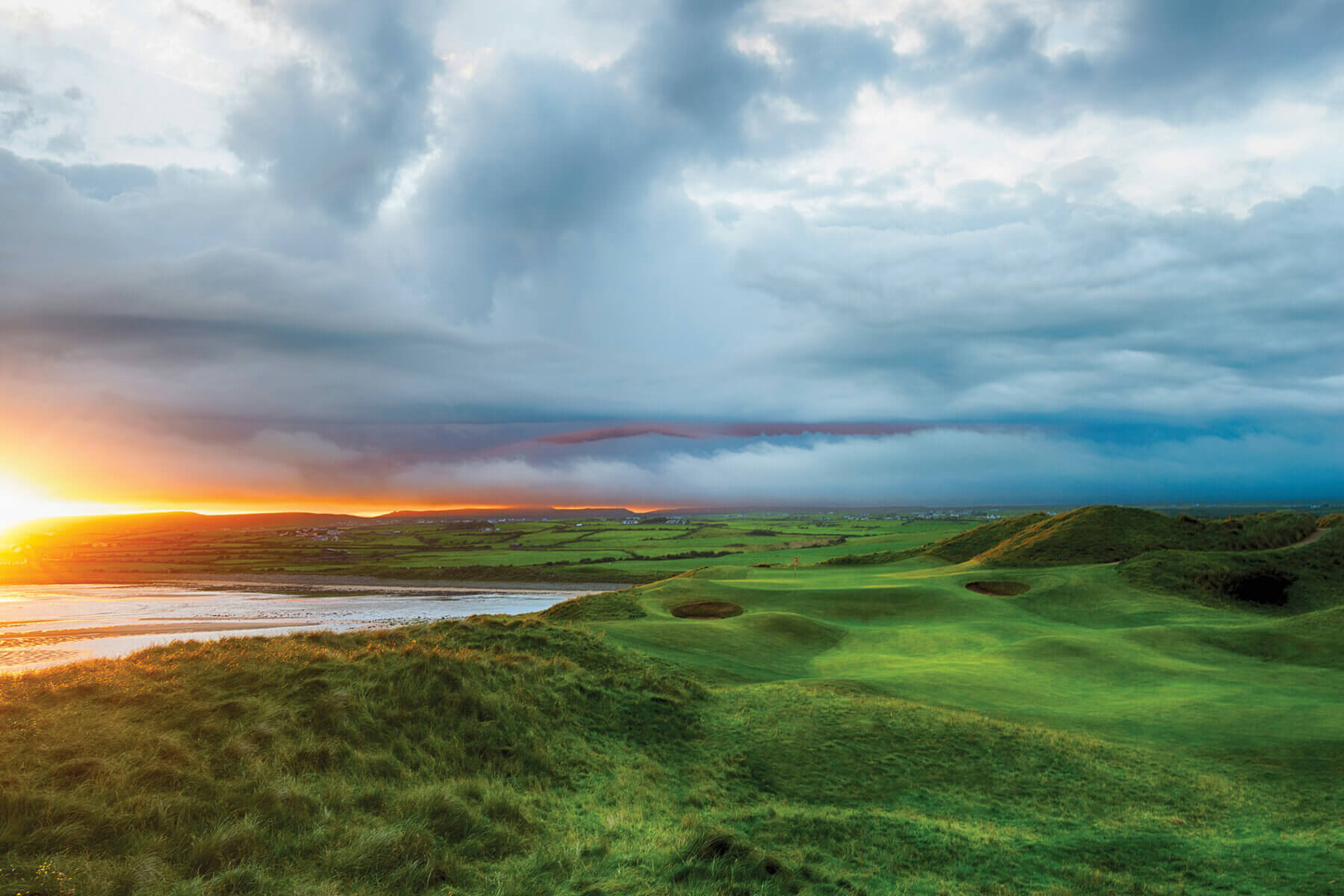 Image looking at the 7th hole at sunset on the old golf course at Lahinch Golf Club, County Clare, Ireland