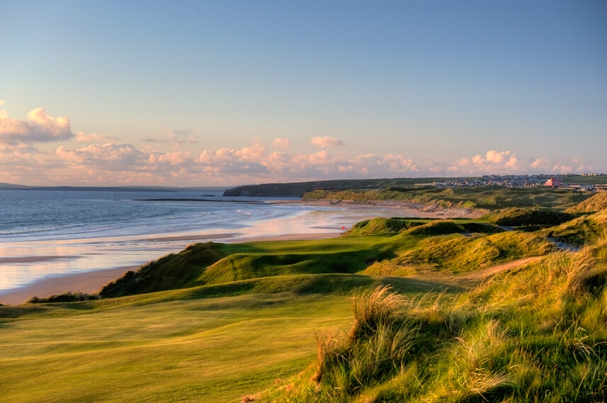 Image depicting the 17th green and distant beach as the sun sets on the Cashen Golf Course at Ballybunion, County Kerry, Ireland