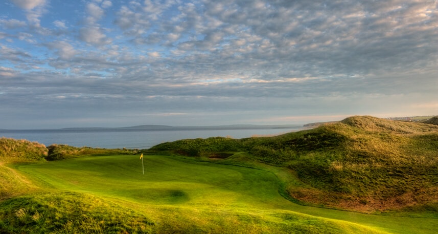 Image displaying the 10th green and distant beach on the Cashen Golf Course at Ballybunion, County Kerry, Ireland
