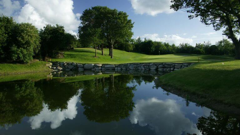 Image of the 10th green and large lake on the golf course at Wolseley Resort, County Carlow, Ireland, Europe