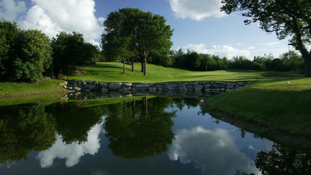 Image of the 10th green and large lake on the golf course at Wolseley Resort, County Carlow, Ireland, Europe