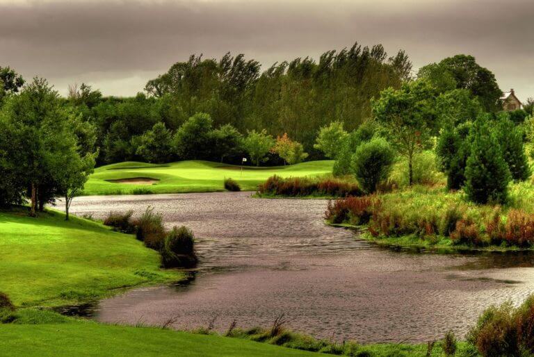 Image looking over a lake at the 8th green on the golf course at Wolseley Resort, County Carlow, Ireland, Europe