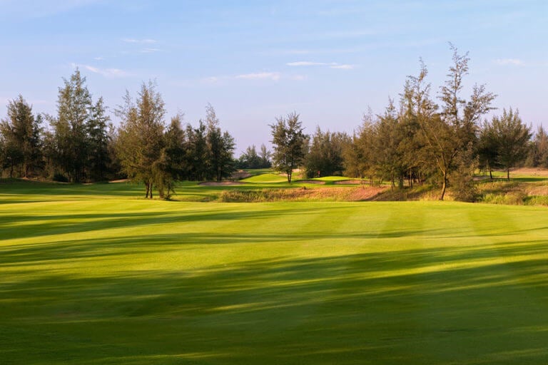 Image of the 10th hole littered with trees at Montgomerie Links Vietnam Golf Course, Da Nang, Vietnam, Asia