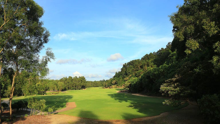 Image looking at the approach on a hole with trees lining the golf course at Laguna Lang Co Golf Club, Da Nang, Vietnam