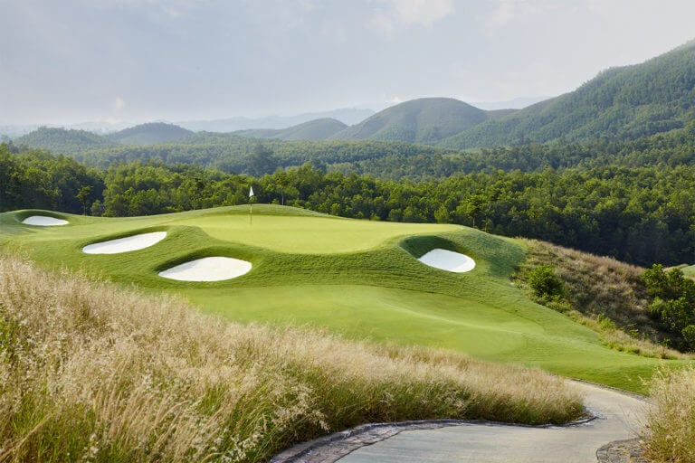 Image of the 12th green and distant mountains at Ba Na Hills Golf Club, Da Nang, Vietnam