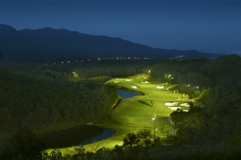 Aerial image of the 11th hole after sunset under floodlights, Ba Na Hills Golf Club, Da Nang, Vietnam